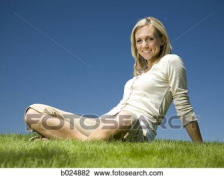 woman sitting on the grass View Large Photo Image Stock Image - woman sitting on the grass. Fotosearch
