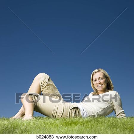 woman sitting on the grass View Large Photo Image Stock Image - woman sitting on the grass. Fotosearch