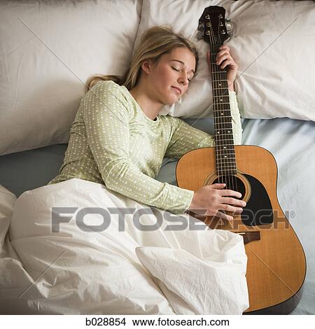 woman sleeping with her guitar View Large Photo Image Picture - woman sleeping with her guitar. Fotosearch