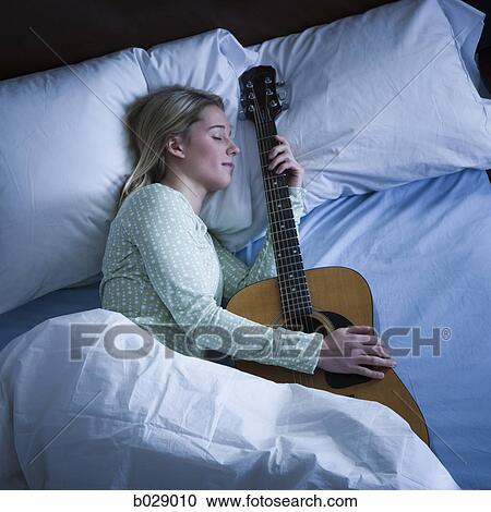 woman sleeping with her guitar View Large Photo Image Stock Image - woman sleeping with her guitar. Fotosearch