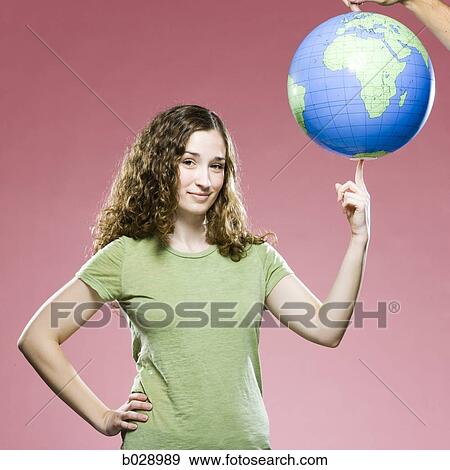 woman spinning a world globe on her finger like a basketball View Large Photo Image Stock Photo - woman spinning a world globe on her finger like a basketball. Fotosearch