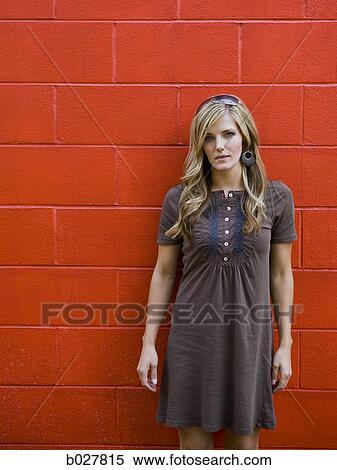 woman standing against a red brick wall View Large Photo Image Stock Photography - woman standing against a red brick wall. Fotosearch