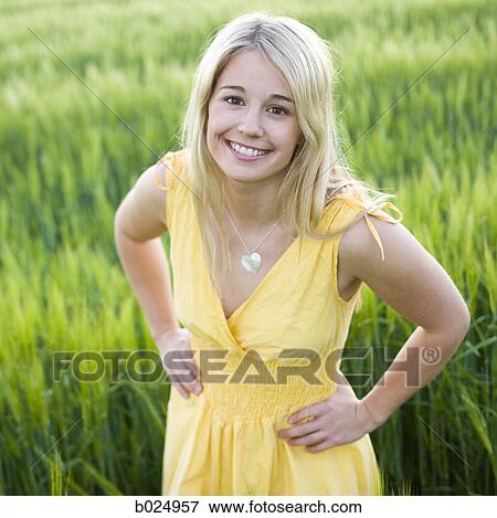 Stock Photo - woman standing in a field. Fotosearch