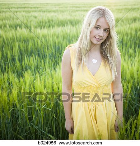 Stock Photograph - woman standing in a field. Fotosearch