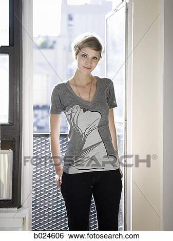 woman standing in front of an open window View Large Photo Image Stock Photograph - woman standing in front of an open window. Fotosearch