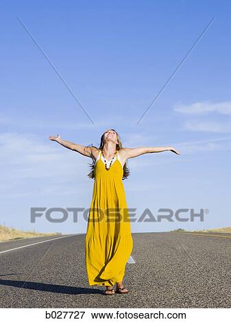 Stock Photo - woman standing in the middle of the road. Fotosearch