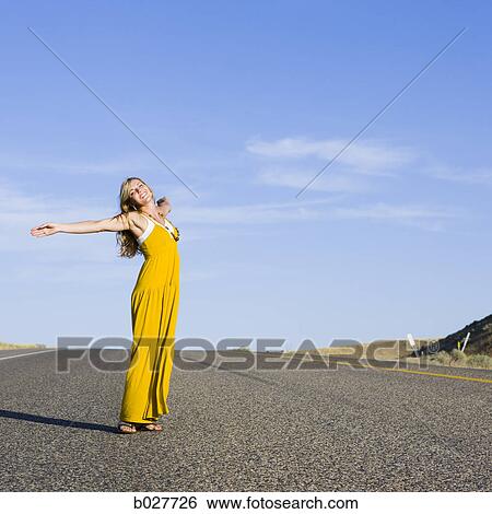 Stock Photograph - woman standing in the middle of the road. Fotosearch