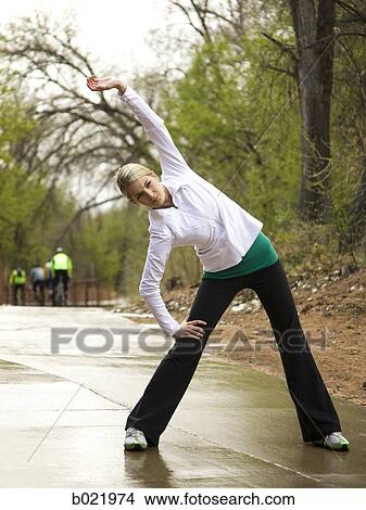 woman stretching before a workout View Large Photo Image Picture - woman stretching before a workout. Fotosearch