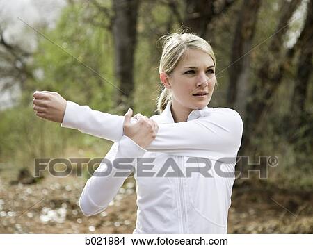Picture - woman stretching before a workout. Fotosearch
