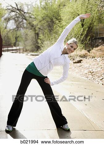 woman stretching before a workout View Large Photo Image Picture - woman stretching before a workout. Fotosearch