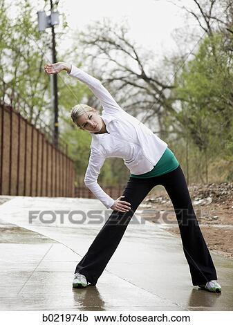 woman stretching before a workout View Large Photo Image Stock Image - woman stretching before a workout. Fotosearch