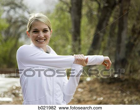 woman stretching before a workout View Large Photo Image Stock Image - woman stretching before a workout. Fotosearch