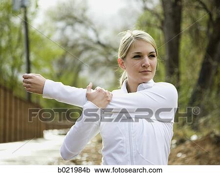 woman stretching before a workout View Large Photo Image Stock Image - woman stretching before a workout. Fotosearch