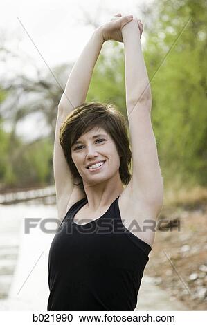 woman stretching before a workout View Large Photo Image Stock Image - woman stretching before a workout. Fotosearch