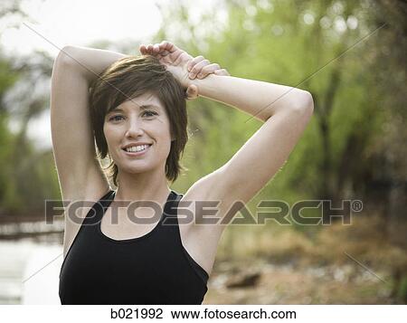 woman stretching before a workout View Large Photo Image Stock Image - woman stretching before a workout. Fotosearch