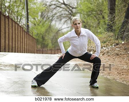 woman stretching before a workout View Large Photo Image Stock Photo - woman stretching before a workout. Fotosearch