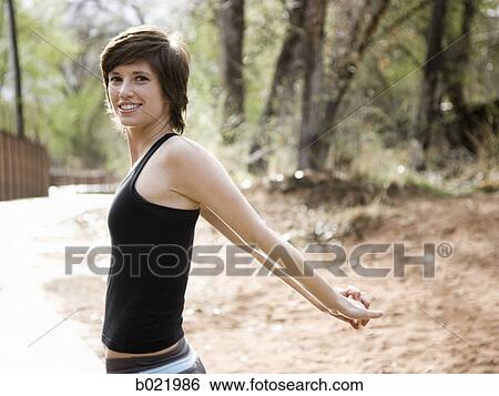 woman stretching before a workout View Large Photo Image Stock Photograph - woman stretching before a workout. Fotosearch