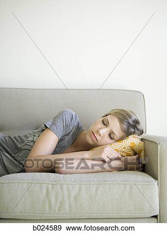 Stock Photo - woman taking a nap on the couch. Fotosearch