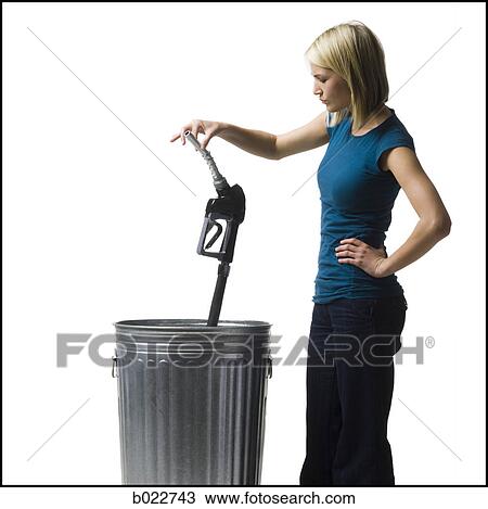 woman throwing a gas pump nozzle in the trash View Large Photo Image Stock Image - woman throwing a gas pump nozzle in the trash. Fotosearch
