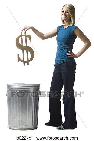 Stock Image - woman throwing dollar symbol in the trash. Fotosearch