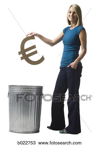 Stock Image - woman throwing euro symbol in the trash. Fotosearch