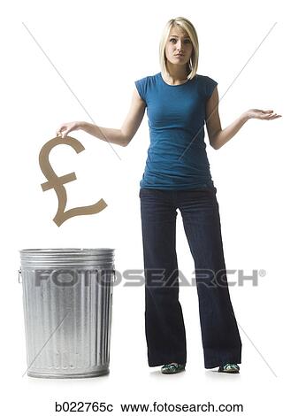 Stock Image - woman throwing pound symbol in the trash. Fotosearch