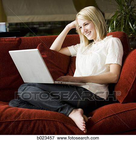 woman using laptop on the couch View Large Photo Image Stock Photo - woman using laptop on the couch. Fotosearch