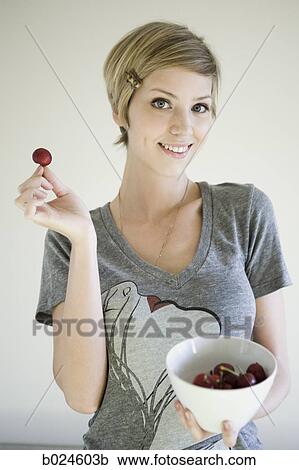 woman with a bowl of cherries View Large Photo Image Stock Image - woman with a bowl of cherries. Fotosearch