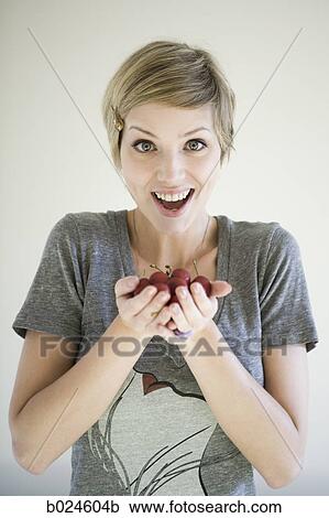 woman with a handful of cherries View Large Photo Image Stock Image - woman with a handful of cherries. Fotosearch