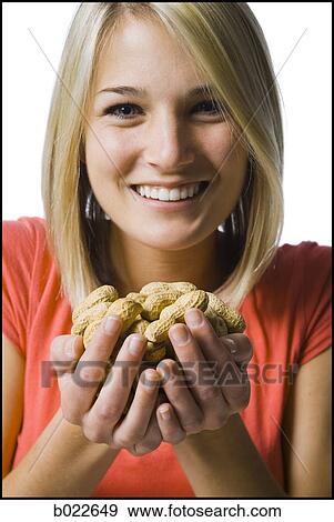 woman with a handfull of peanuts View Large Photo Image Stock Photo - woman with a handfull of peanuts. Fotosearch