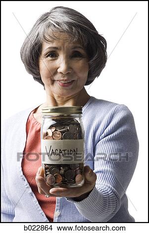 Picture - woman with a jar full of coins. Fotosearch