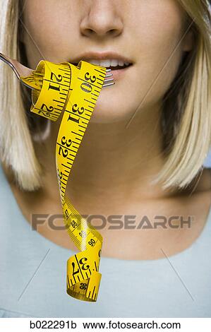 woman with a measuring tape on a fork View Large Photo Image Stock Image - woman with a measuring tape on a fork. Fotosearch