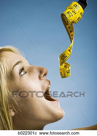 woman with a measuring tape on a fork View Large Photo Image Stock Image - woman with a measuring tape on a fork. Fotosearch