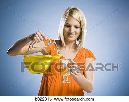 Stock Photography - woman with a pitcher of lemonade. Fotosearch