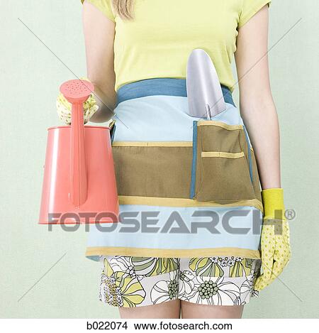 woman with a watering can View Large Photo Image Picture - woman with a watering can. Fotosearch