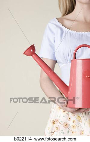woman with a watering can View Large Photo Image Picture - woman with a watering can. Fotosearch