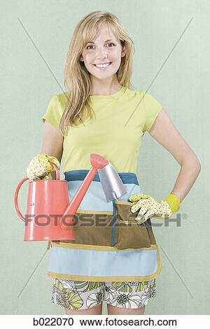 woman with a watering can View Large Photo Image Stock Image - woman with a watering can. Fotosearch