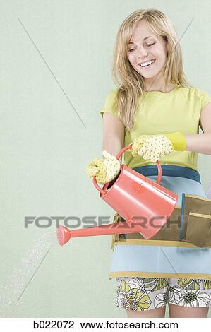 Stock Image - woman with a watering can. Fotosearch