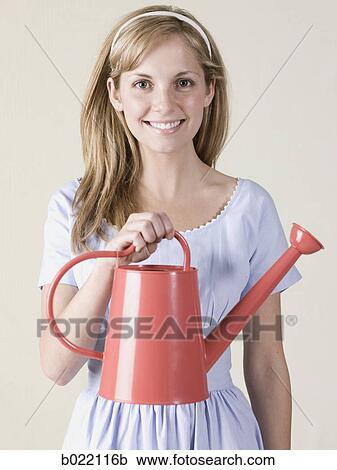 woman with a watering can View Large Photo Image Stock Image - woman with a watering can. Fotosearch
