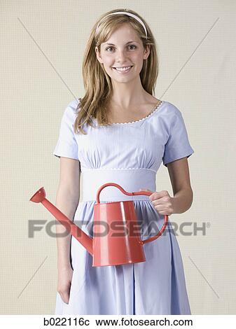 woman with a watering can View Large Photo Image Stock Image - woman with a watering can. Fotosearch