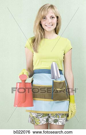 woman with a watering can View Large Photo Image Stock Photograph - woman with a watering can. Fotosearch