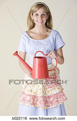 woman with a watering can View Large Photo Image Stock Photograph - woman with a watering can. Fotosearch