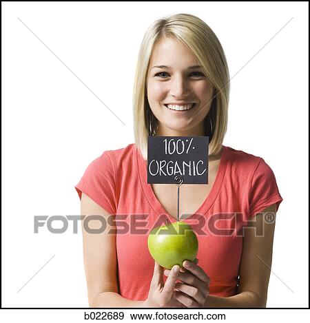 Stock Photo - woman with an organic apple. Fotosearch