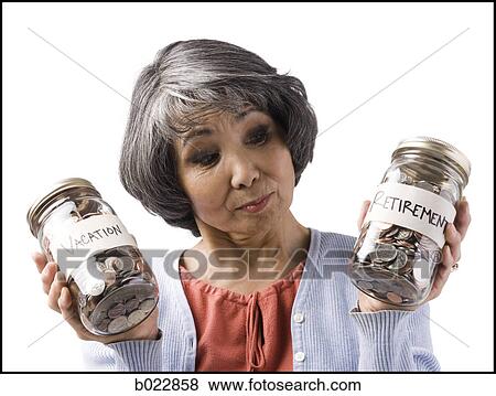 Stock Photo - woman with two jars of coins. Fotosearch