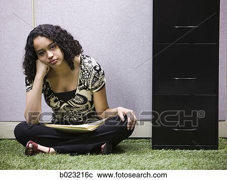 Stock Image - woman working in her "green" office. Fotosearch