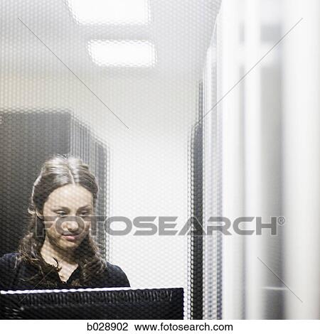 woman working on a computer shot through a metal screen View Large Photo Image Stock Image - woman working on a computer shot through a metal screen. Fotosearch