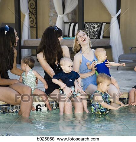 Stock Photo - women by the pool with their babies. Fotosearch