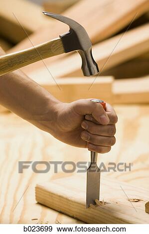 working on wood with a hammer and chisel View Large Photo Image Stock Photo - working on wood with a hammer and chisel. Fotosearch