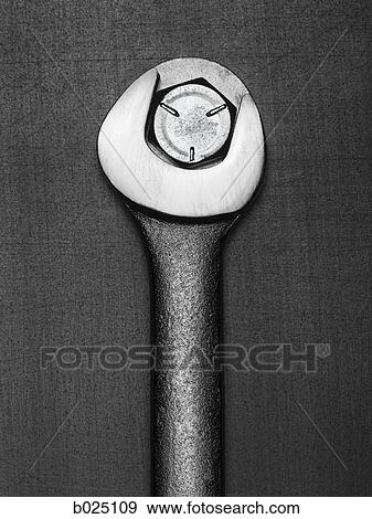 wrench turning a bolt View Large Photo Image Stock Photo - wrench turning a bolt. Fotosearch