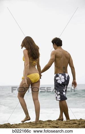 young couple at the beach holding hands View Large Photo Image Stock Image - young couple at the beach holding hands. Fotosearch